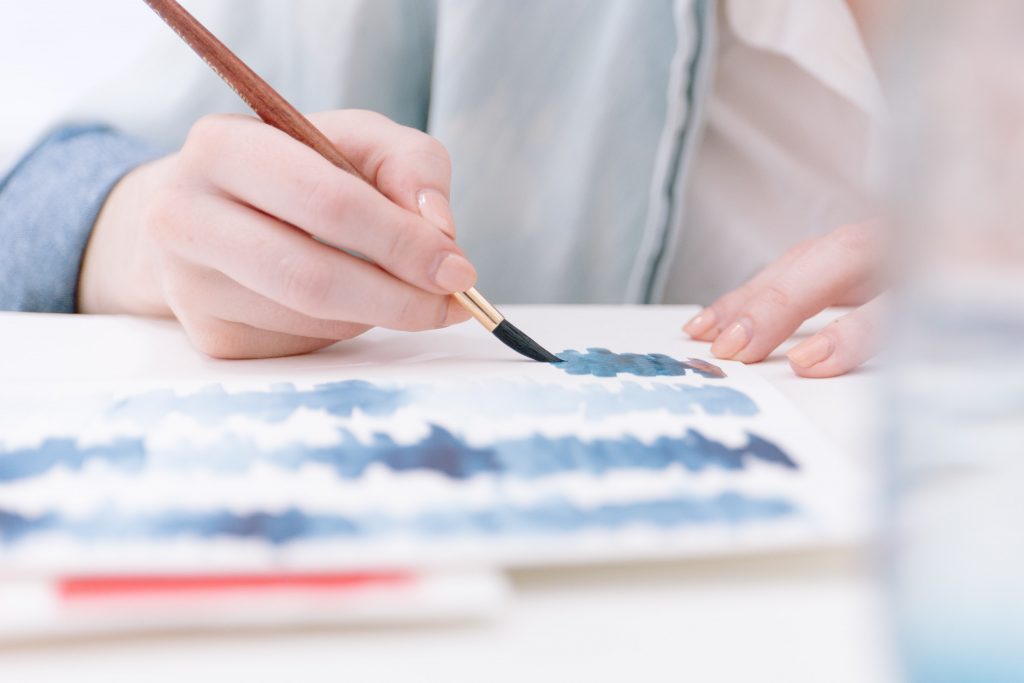 A person holding a paintbrush